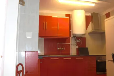a kitchen with orange and red cabinets in a room at Mira Porto House in Vila Nova de Gaia
