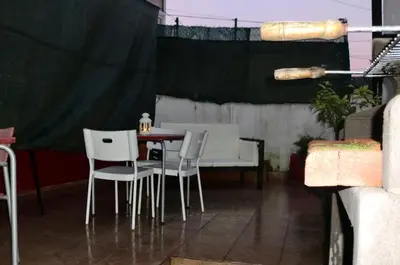 a patio with a table and white chairs at Mira Porto House in Vila Nova de Gaia