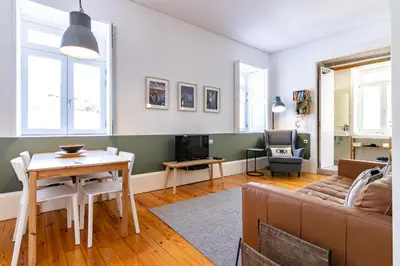 a living room with a couch and a table at Cozy Studio Apartment in Porto