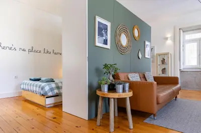 a living room with a couch and a table at Cozy Studio Apartment in Porto