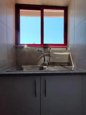 a kitchen with a sink and a window at Apartamento Boavista in Vila Nova de Gaia