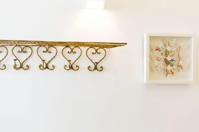 a shelf with two framed pictures on a white wall at Our Home City Flat in Porto