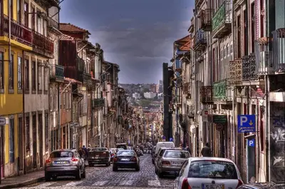 a busy city street filled with cars and buildings at Our Home City Flat in Porto