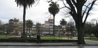 a man walking down a sidewalk in front of a large building at Our Home City Flat in Porto