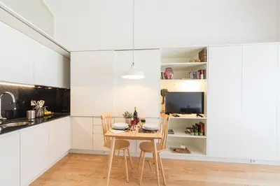 a dining room with a table and chairs in a kitchen at Bright Downtown Apartment in Porto