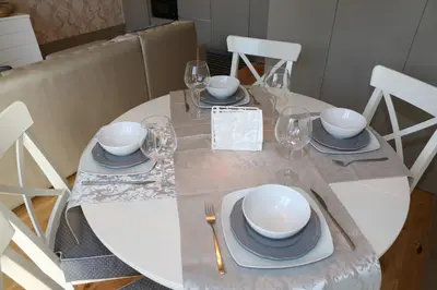 a dining table with plates and glasses on it at Cozy Flat Porto Downtown in Porto
