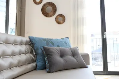 a couch with pillows on it in a living room at Cozy Flat Porto Downtown in Porto