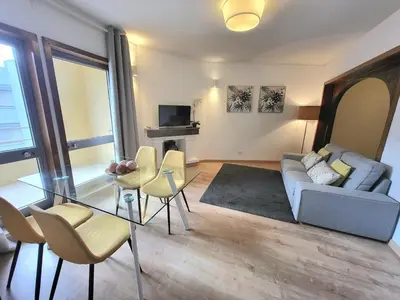 a living room with a couch and a table and chairs at Vale Formoso Apartment in Porto