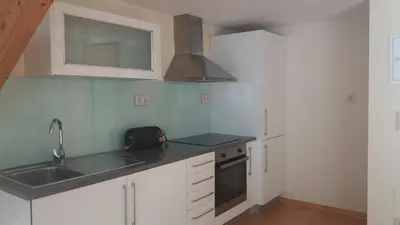 a kitchen with a sink and a stove at Pachecos in Porto