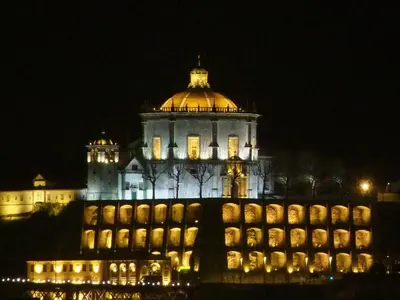 a lit up building with a dome on top at night at O'Porto Cheers Gaia in Vila Nova de Gaia