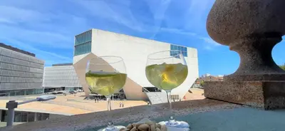 two glasses of white wine sitting on a ledge at Boavista Class Inn in Porto