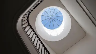 a round window in a building with a spiral staircase at Studio Sta in Porto