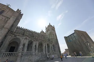 a large stone building with a clock tower on it at FLH Porto Comfort Flat in Porto