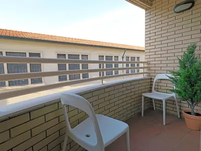 a balcony with two chairs and a table and a plant at FLH Porto Comfort Flat in Porto