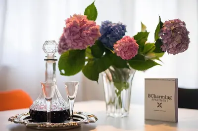 a table with a vase of flowers on a table with a vase at BCharming House in Porto