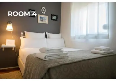 a bedroom with a bed with towels on it at BCharming House in Porto
