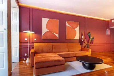 a bed with a red padded headboard in a room at Myo Design House by LovelyStay in Porto