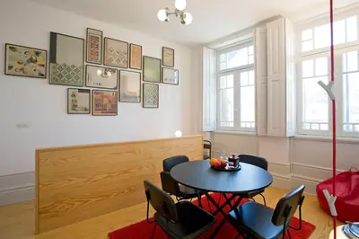 a dining room with a table and chairs at 14º Esquadra — Cais das Pedras Guest House in Porto