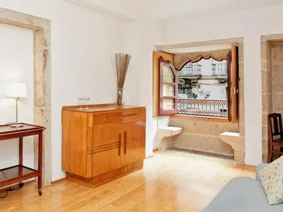 a living room with a wooden cabinet and a mirror at Flowerstreet54 in Porto