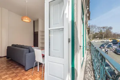 a door leading to a balcony with a couch at GuestReady - Clérigos Virtudes Apartments in Porto