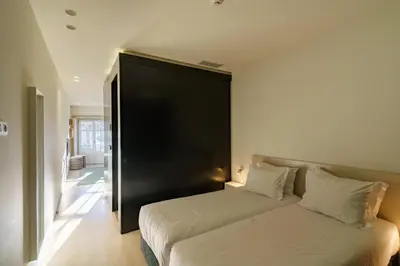 a bedroom with a bed with a black headboard at N Apartments - Chã in Porto