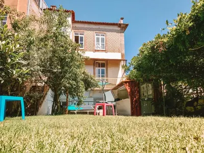 a yard with a house and a playground at Urban Garden Porto Central Hostel in Porto