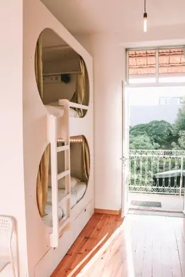 a room with a large mirror on the wall at Urban Garden Porto Central Hostel in Porto