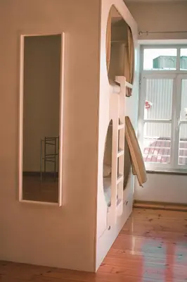a room with a shelf and a mirror at Urban Garden Porto Central Hostel in Porto