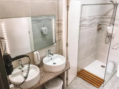 a bathroom with a sink and a shower at Urban Garden Porto Central Hostel in Porto