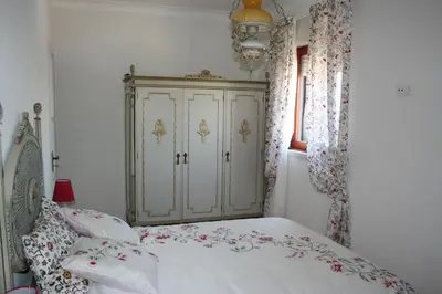 a bedroom with a bed and a white cabinet at Bom dia Porto in Vila Nova de Gaia