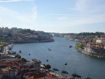 a view of a river with boats in a city at Bom dia Porto in Vila Nova de Gaia