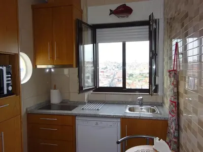a small kitchen with a sink and a window at Bom dia Porto in Vila Nova de Gaia