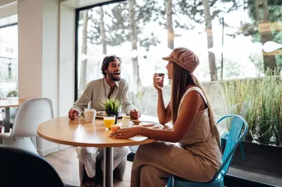 a man and woman sitting at a table in a restaurant at Stay Hotel Porto Centro Trindade in Porto