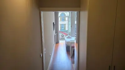 a hallway with a door to a room with a table at São Bento Front Homy Studio in Porto