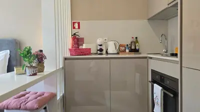 a small kitchen with a counter and a sink at São Bento Front Homy Studio in Porto