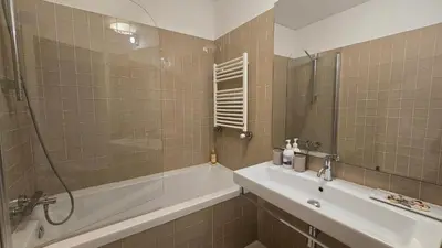 a bathroom with a tub and a sink and a shower at São Bento Front Homy Studio in Porto