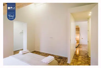 a white room with a bed and a hallway at ORM - Saraiva de Carvalho Apartments in Porto