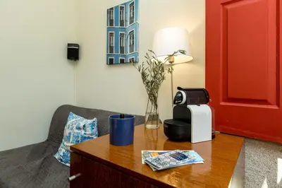 a room with a table with a toaster and a chair at Flores Lofts in Porto