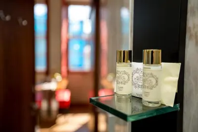 two bottles of moisturizers sitting on a glass table at Flores Lofts in Porto