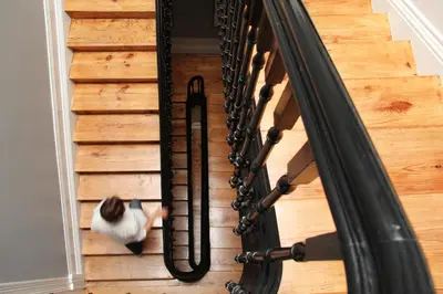 a cat sitting on the stairs next to a spiral staircase at Porto Music Guest House in Porto