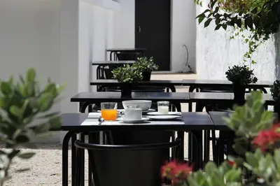 a group of tables with plates and drinks on them at Porto Music Guest House in Porto