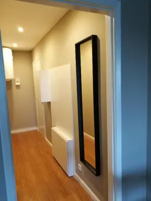 a hallway with a mirror on the wall at Pontocom Bolhão Apartment in Porto
