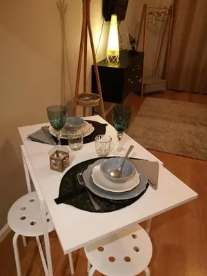 a white table with plates and wine glasses on it at Pontocom Bolhão Apartment in Porto