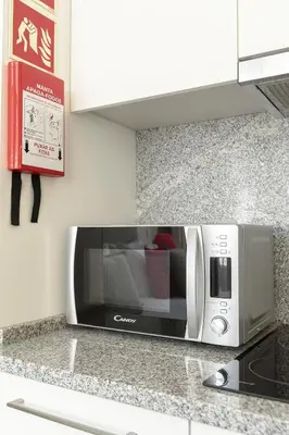 a microwave oven on a counter in a kitchen at Charming Balcony Apartment in Historic Ribeira - Inside Porto Apartments 