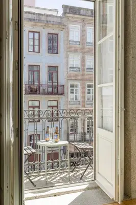 an open door to a balcony with a table at Charming Balcony Apartment in Historic Ribeira - Inside Porto Apartments 