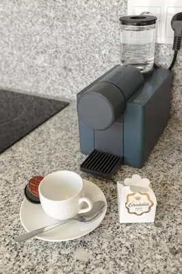 a coffee maker with a cup and aucer on a counter at Charming Balcony Apartment in Historic Ribeira - Inside Porto Apartments 