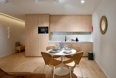 a kitchen with a table and chairs in a room at Oporto Coliseum Residence in Porto