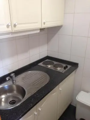 a kitchen with a sink and a counter top at Seculo apartments in Porto