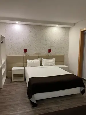 a bedroom with a large bed with two night stands at Seculo apartments in Porto