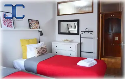 a bedroom with a bed with a red blanket at Country Apartment by JC in Porto